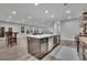 Spacious open-concept kitchen featuring an island, stainless steel appliances, and light wood flooring at 430 Parkbrook Way, Canton, GA 30114