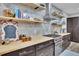 Close up of the kitchen with wood countertop, stainless appliances, and floating shelves at 430 Parkbrook Way, Canton, GA 30114