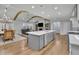 Bright, open kitchen featuring a large island with sink and dishwasher and view into living room at 430 Parkbrook Way, Canton, GA 30114