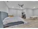 Comfortable main bedroom with light wood floors, ceiling fan, and neutral color palette at 430 Parkbrook Way, Canton, GA 30114