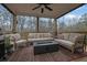 Comfortable covered patio with outdoor seating and a warm fire pit feature at 430 Parkbrook Way, Canton, GA 30114