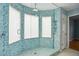 Bathroom shower boasts blue mosaic tile, glass doors, and modern hardware at 1002 Defoors Nw Lndg, Atlanta, GA 30318