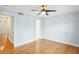 Light and bright bedroom shows hardwood floors, ceiling fan, and access to other rooms at 1002 Defoors Nw Lndg, Atlanta, GA 30318