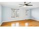 Bright bedroom features hardwood floors, a ceiling fan, and two windows for plenty of natural light at 1002 Defoors Nw Lndg, Atlanta, GA 30318