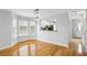 Dining area with hardwood floors and natural light, open to kitchen, and hallway at 1002 Defoors Nw Lndg, Atlanta, GA 30318