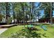 Outdoor area with colorful chairs on green turf, perfect for gatherings at The Camp at 1002 Defoors Nw Lndg, Atlanta, GA 30318
