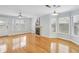 Bright living room with fireplace, ceiling fan, and multiple windows, showcasing hardwood floors at 1002 Defoors Nw Lndg, Atlanta, GA 30318