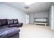 A recreation room boasting a tanning bed, leather couch and storage shelf at 2657 Neighborhood S Walk, Villa Rica, GA 30180