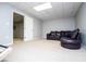 Relaxing basement area featuring plush carpeting and a comfortable leather sofa at 2657 Neighborhood S Walk, Villa Rica, GA 30180