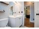 Bathroom with a white vanity and black hardware open to the hallway and living room at 2657 Neighborhood S Walk, Villa Rica, GA 30180