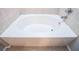 Well-maintained white bathtub with tiled walls, perfect for a relaxing bath in a clean and modern bathroom at 2657 Neighborhood S Walk, Villa Rica, GA 30180