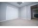 Spacious bedroom features plush carpeting, light grey walls, and closet providing a versatile living space at 2657 Neighborhood S Walk, Villa Rica, GA 30180