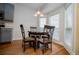 Cozy breakfast nook featuring hardwood floors, a round table, four chairs, and a bay window with natural light at 2657 Neighborhood S Walk, Villa Rica, GA 30180