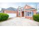 A stunning brick home features an attached garage and a well-kept yard at 2657 Neighborhood S Walk, Villa Rica, GA 30180