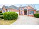 Beautiful brick home with manicured bushes, a garage, and a long driveway at 2657 Neighborhood S Walk, Villa Rica, GA 30180