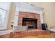 Close up of the brick fireplace with white mantel and a black metal screen at 2657 Neighborhood S Walk, Villa Rica, GA 30180