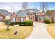 Charming brick home features a well-manicured lawn and a paved driveway leading to the entrance at 2657 Neighborhood S Walk, Villa Rica, GA 30180