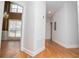 Hallway with hardwood floors, white walls and trim, and a view into a living room at 2657 Neighborhood S Walk, Villa Rica, GA 30180