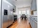 Galley kitchen with stainless steel appliances, gray cabinets, and breakfast nook with large windows at 2657 Neighborhood S Walk, Villa Rica, GA 30180