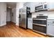 Updated kitchen features stainless steel appliances, gray cabinets, and ample counter space at 2657 Neighborhood S Walk, Villa Rica, GA 30180