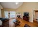 Inviting living room with brick fireplace, large window, and hardwood floors at 2657 Neighborhood S Walk, Villa Rica, GA 30180