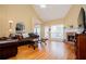 Inviting living room with vaulted ceiling, hardwood floors, brick fireplace, and plenty of natural light at 2657 Neighborhood S Walk, Villa Rica, GA 30180