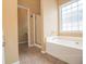 Main bathroom with a soaking tub, shower, and private toilet room at 2657 Neighborhood S Walk, Villa Rica, GA 30180