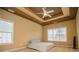 Spacious main bedroom with a tray ceiling, ceiling fan, two windows, and carpet flooring at 2657 Neighborhood S Walk, Villa Rica, GA 30180