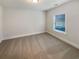 Clean, neutral bedroom with carpeting and a window offering plenty of natural light at 6503 Foggy Oak Dr, Fairburn, GA 30213