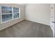 Bright bedroom with a large window providing natural light and neutral carpeting at 6503 Foggy Oak Dr, Fairburn, GA 30213