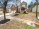 Charming two-story brick home featuring a two-car garage, front porch, and landscaped yard at 6503 Foggy Oak Dr, Fairburn, GA 30213