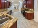 Spacious kitchen boasts stainless steel appliances, granite countertops, and rich wood cabinetry at 6503 Foggy Oak Dr, Fairburn, GA 30213