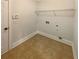 Functional laundry room with tile flooring and a wire shelf for added storage at 6503 Foggy Oak Dr, Fairburn, GA 30213