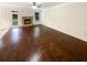 Bright living room featuring hardwood floors, a cozy stone fireplace, and white wainscoting at 6503 Foggy Oak Dr, Fairburn, GA 30213