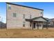 View of the home's backyard featuring a covered porch and light brick exterior at 825 Bufflehead Ct, Stockbridge, GA 30281