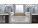 Elegant bathroom with large soaking tub and granite countertops with double sinks at 825 Bufflehead Ct, Stockbridge, GA 30281
