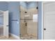 Shower stall with neutral-tone tile, glass door and multiple shower heads at 825 Bufflehead Ct, Stockbridge, GA 30281