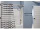 Full bathroom with tub and shower combination, and striped shower curtain at 825 Bufflehead Ct, Stockbridge, GA 30281