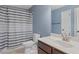 Well-lit bathroom features a shower with tub and vanity with sink at 825 Bufflehead Ct, Stockbridge, GA 30281