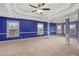Spacious bedroom featuring a tray ceiling, ceiling fan, and generous natural light at 825 Bufflehead Ct, Stockbridge, GA 30281