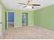 Spacious bedroom features neutral carpet, bright walls, and a ceiling fan at 825 Bufflehead Ct, Stockbridge, GA 30281