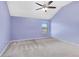 Cozy bedroom features neutral carpet, a ceiling fan, and a large window at 825 Bufflehead Ct, Stockbridge, GA 30281