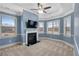 Bright and spacious bedroom with carpeted floor, ceiling fan, fireplace, and large windows at 825 Bufflehead Ct, Stockbridge, GA 30281