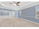 Large bedroom with a tray ceiling, fireplace and large windows with natural light at 825 Bufflehead Ct, Stockbridge, GA 30281