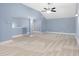Large carpeted bedroom with vaulted ceilings, modern lighting, and neutral walls at 825 Bufflehead Ct, Stockbridge, GA 30281