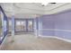 Bright bedroom showcasing a tray ceiling, decorative columns, and plentiful windows at 825 Bufflehead Ct, Stockbridge, GA 30281
