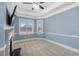 Well-lit primary bedroom with neutral walls, a fireplace, a ceiling fan, and large windows at 825 Bufflehead Ct, Stockbridge, GA 30281