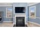 Bedroom featuring a fireplace, neutral-colored walls, carpet and large windows for light at 825 Bufflehead Ct, Stockbridge, GA 30281