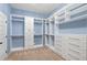 Spacious walk-in closet with custom shelving and ample storage for clothes, shoes, and accessories at 825 Bufflehead Ct, Stockbridge, GA 30281