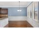 A bright dining area features hardwood floors, natural light, and wainscotting at 825 Bufflehead Ct, Stockbridge, GA 30281